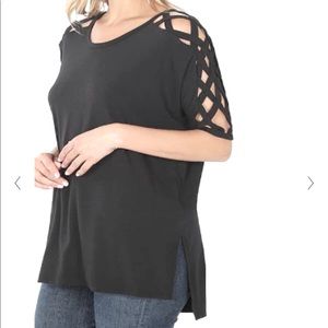 Black top with criss-cross shoulder sleeves. Size small. Worn once